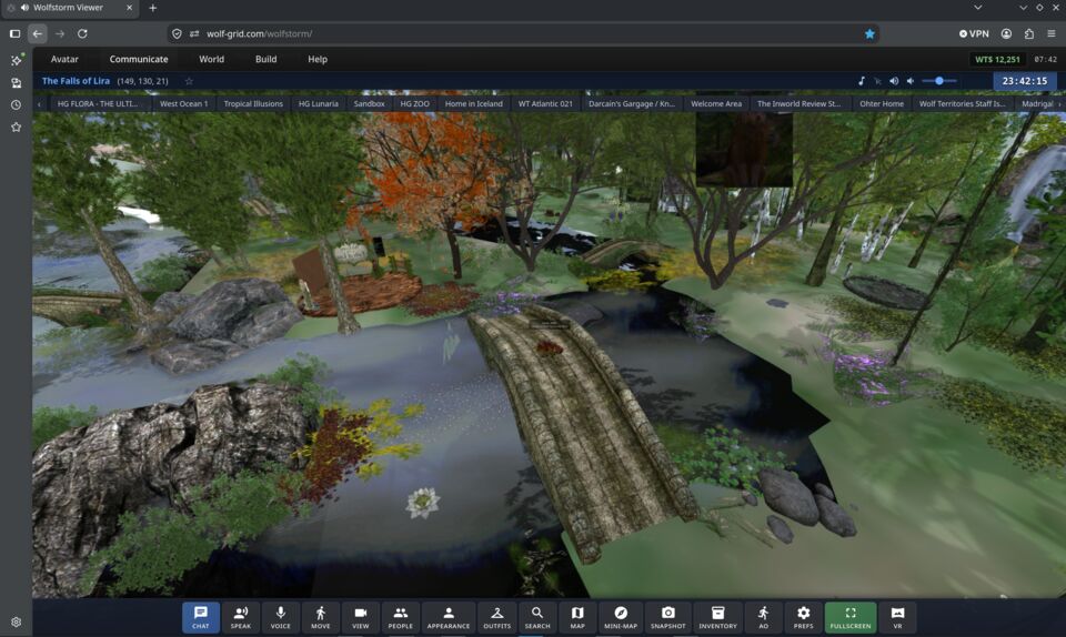 WolfStorm running in a browser tab: a wooded region with a stone bridge over a river, with chat, voice, map and inventory buttons along the bottom.